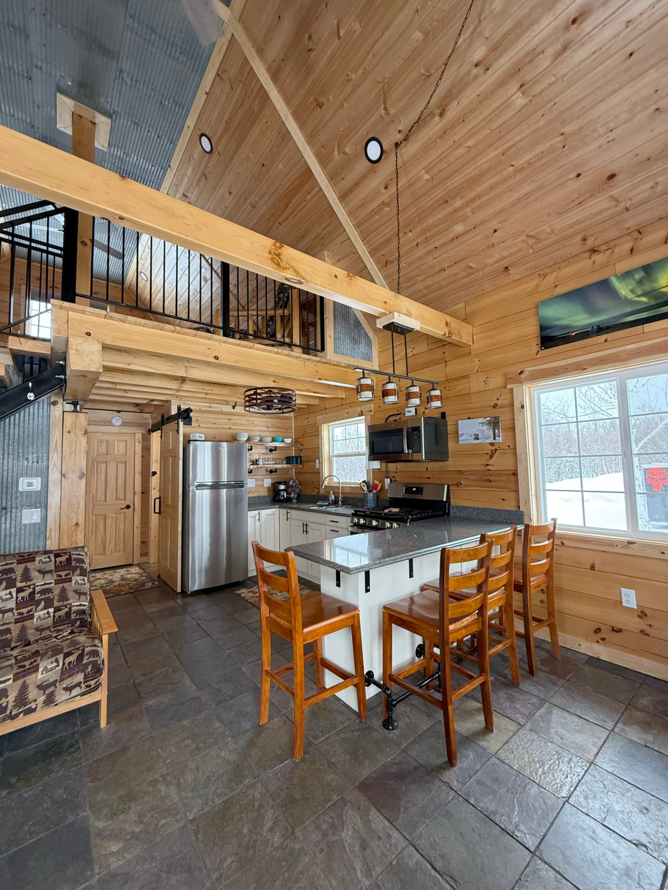 Modern kitchen with breakfast bar and loft above
