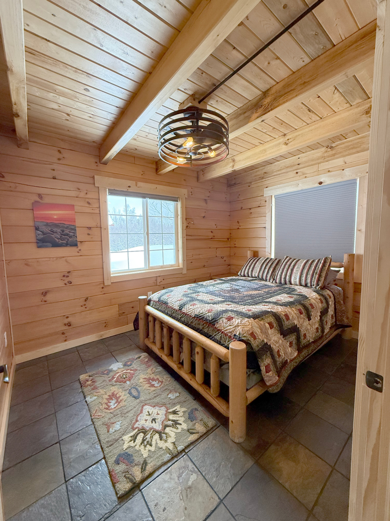 Main-floor bedroom with queen log bed