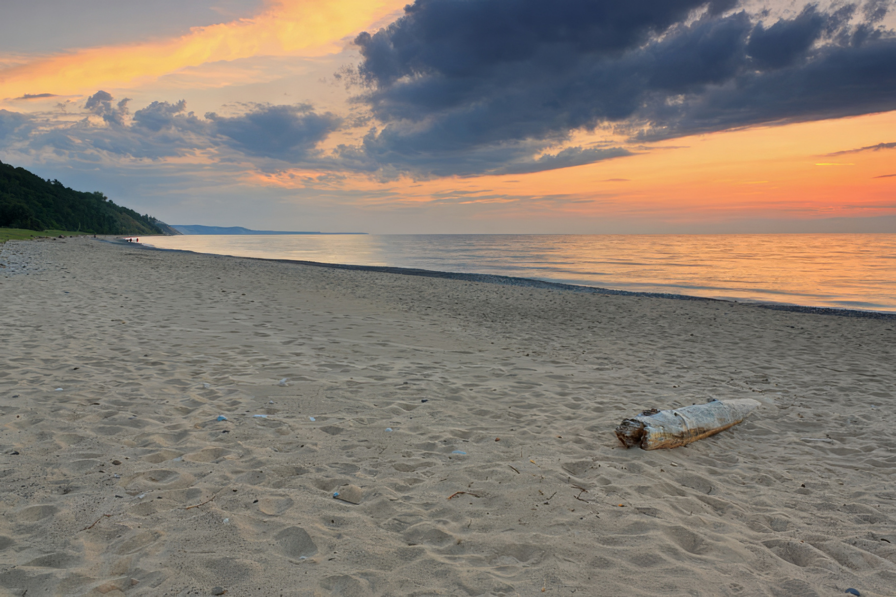 Grand Marais beach at sunset with warm sky over Lake Superior