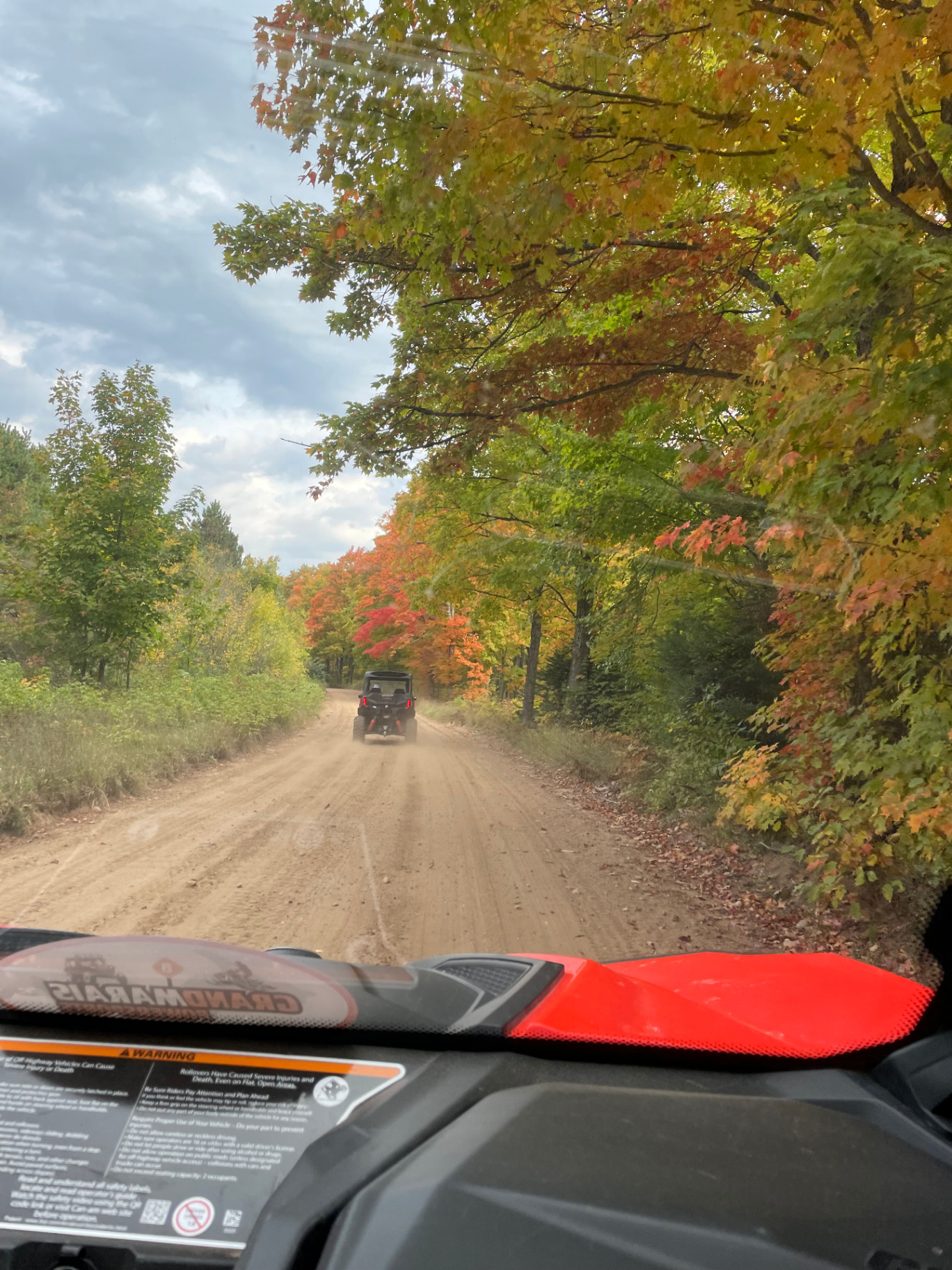 ORV riding down a fall-colored trail near Grand Marais