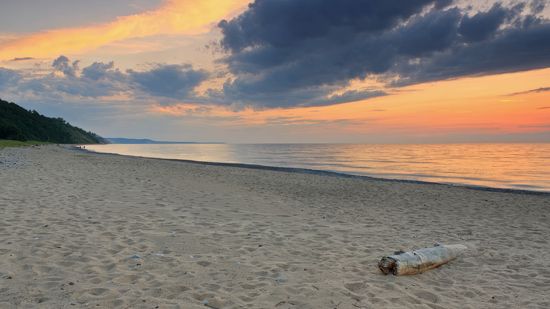 Grand Marais beach at sunset with warm orange sky over Lake Superior